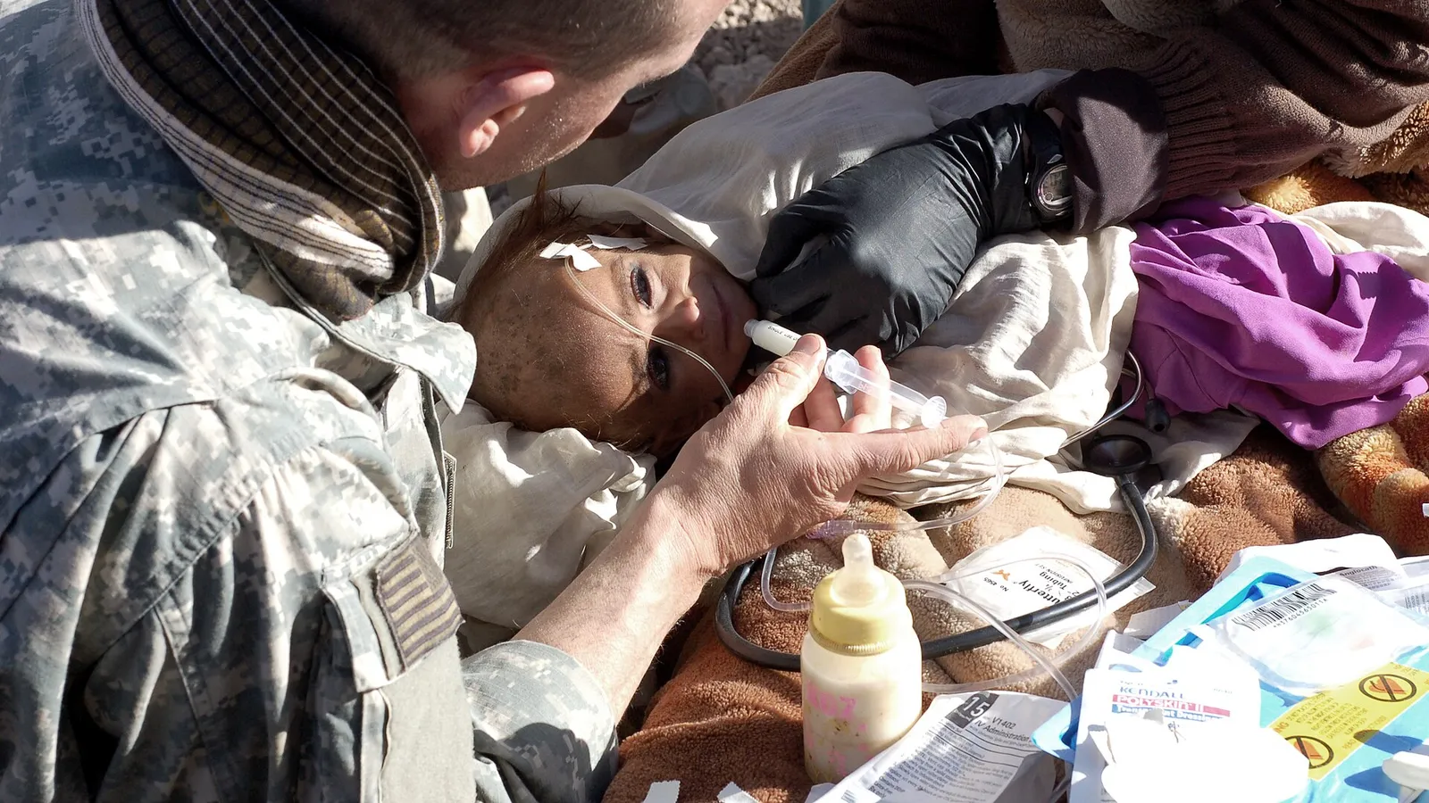 A medic treats a malnourished Afghan child