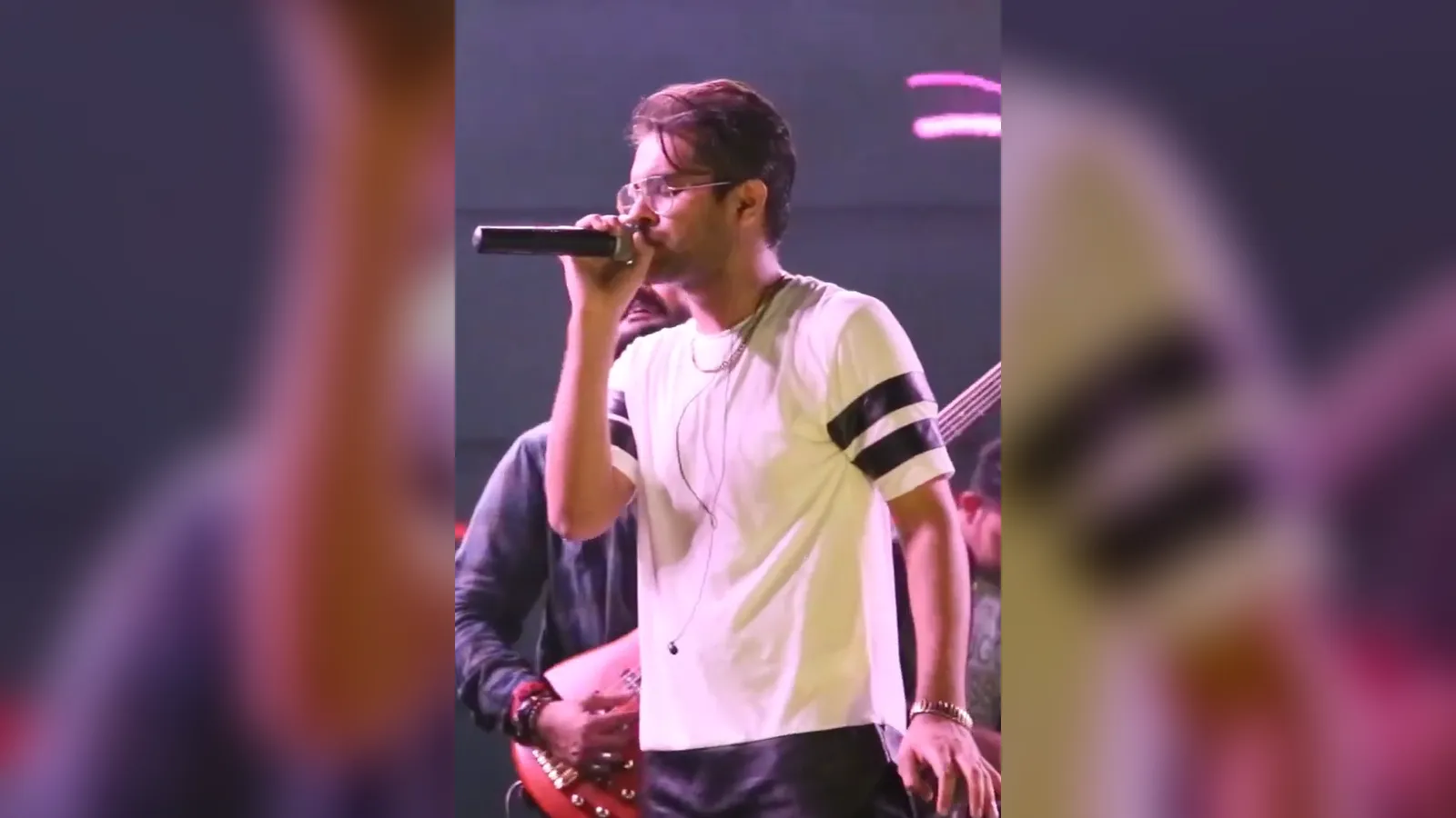 Singer Asim Azhar performing on stage with a microphone