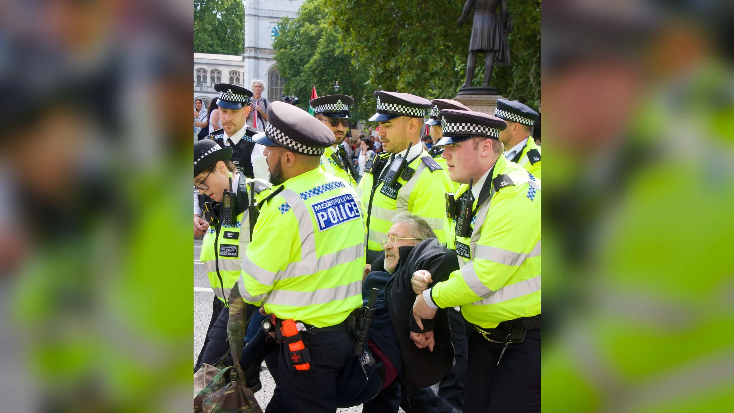 British police officers detain a protester at a Palestine Action protest in London