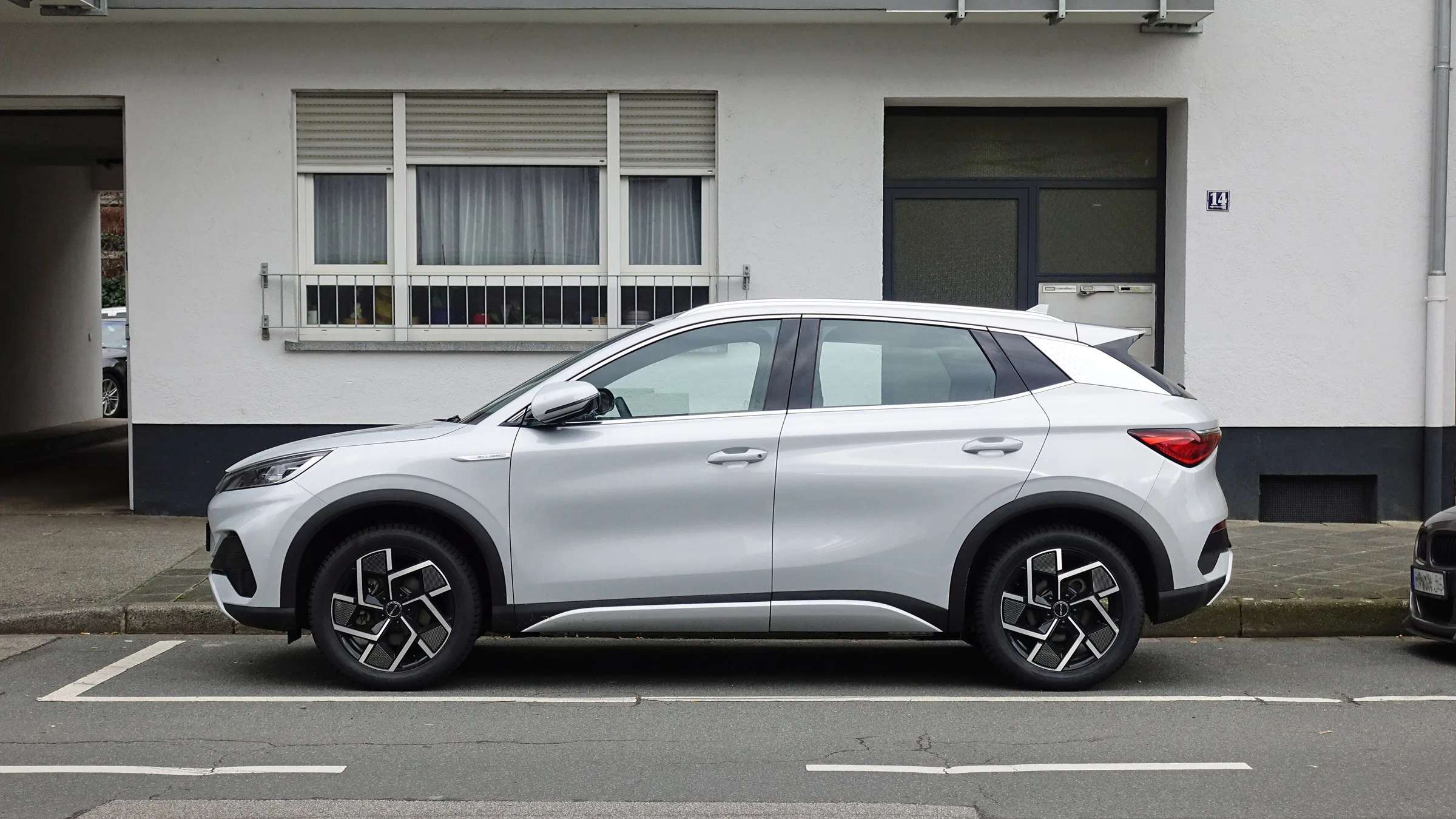 A white BYD Atto 3 electric SUV parked on a street