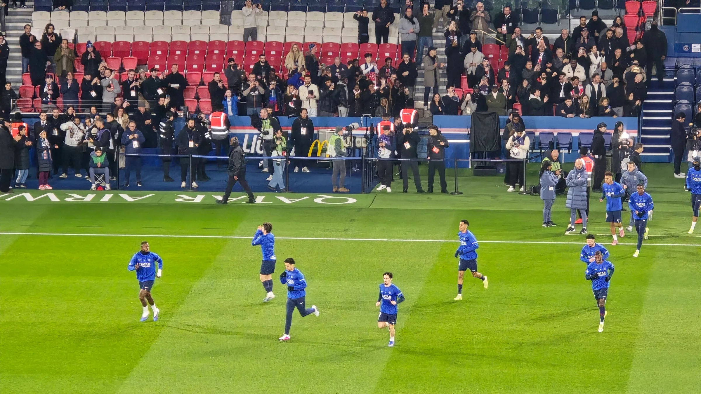Paris Saint-Germain players on the pitch at the Parc des Princes in front of a crowd
