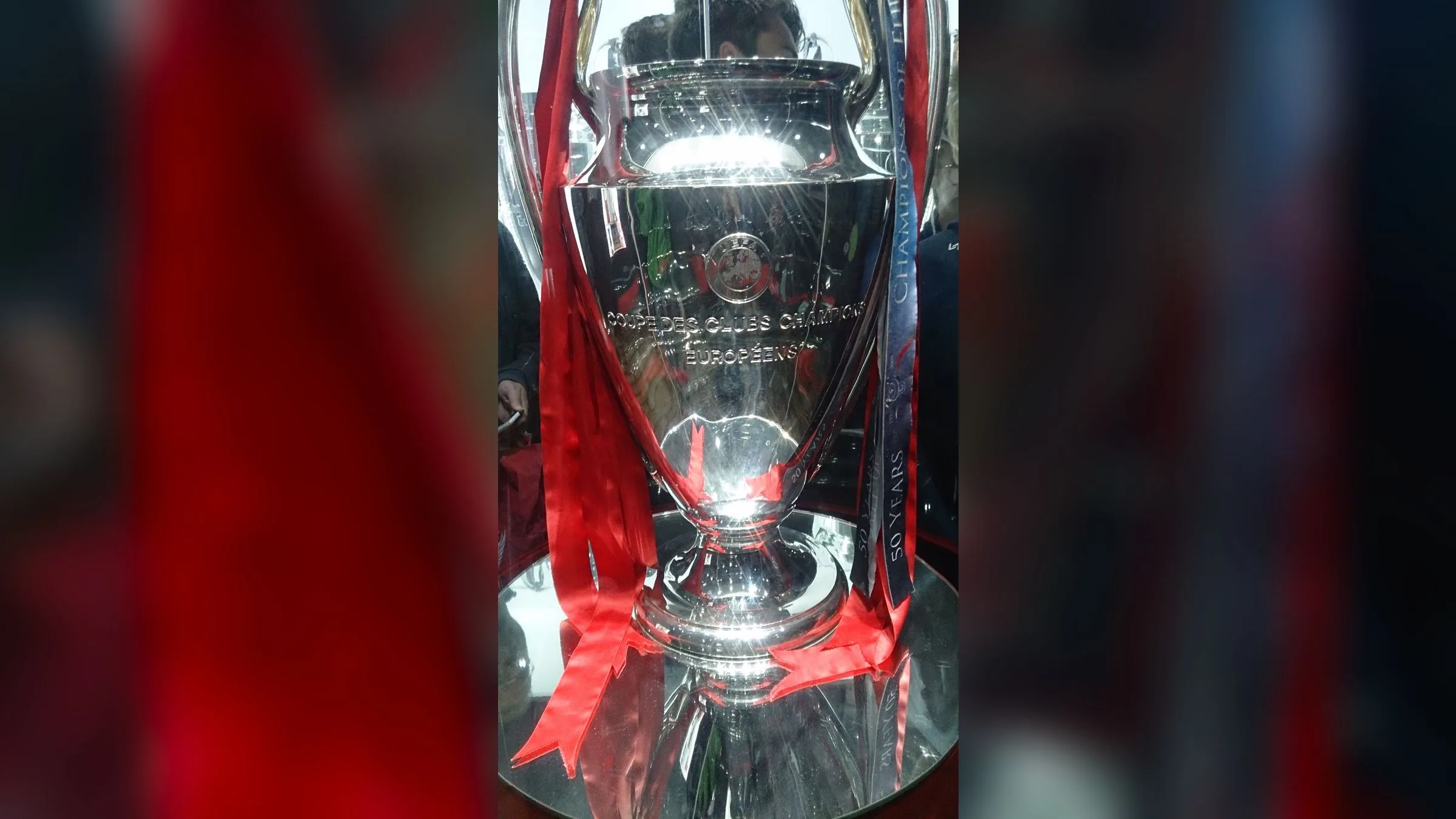 The silver UEFA Champions League trophy with red ribbons