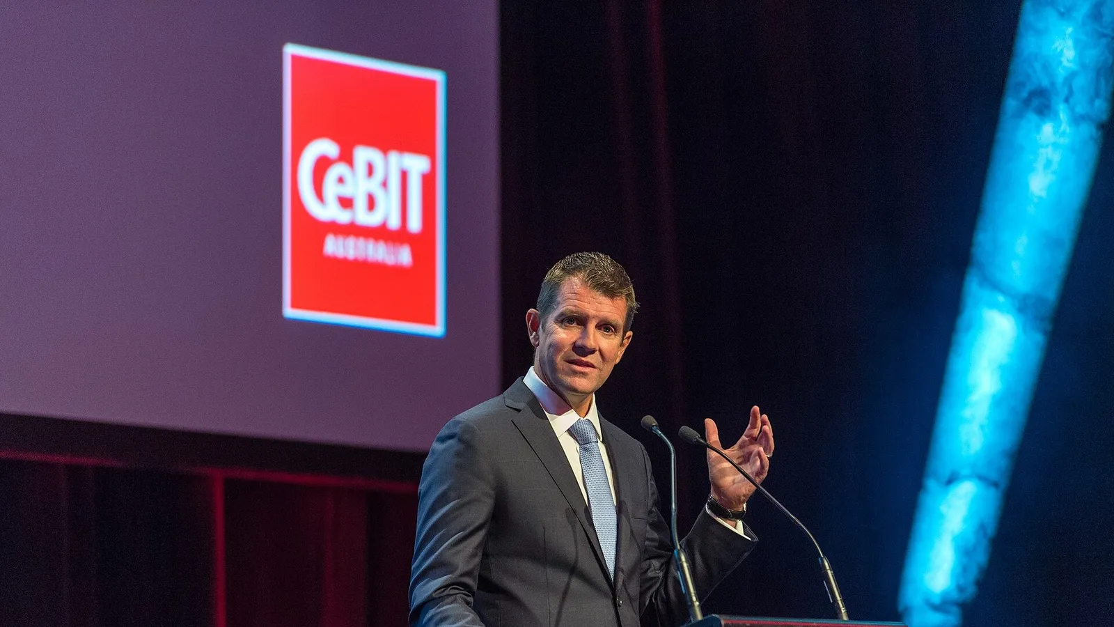 Mike Baird speaking at a podium during a conference