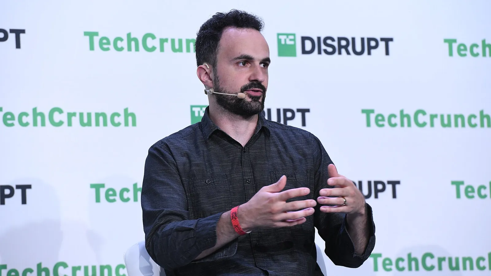 Citizen Lab researcher Bill Marczak speaking on stage at a technology conference