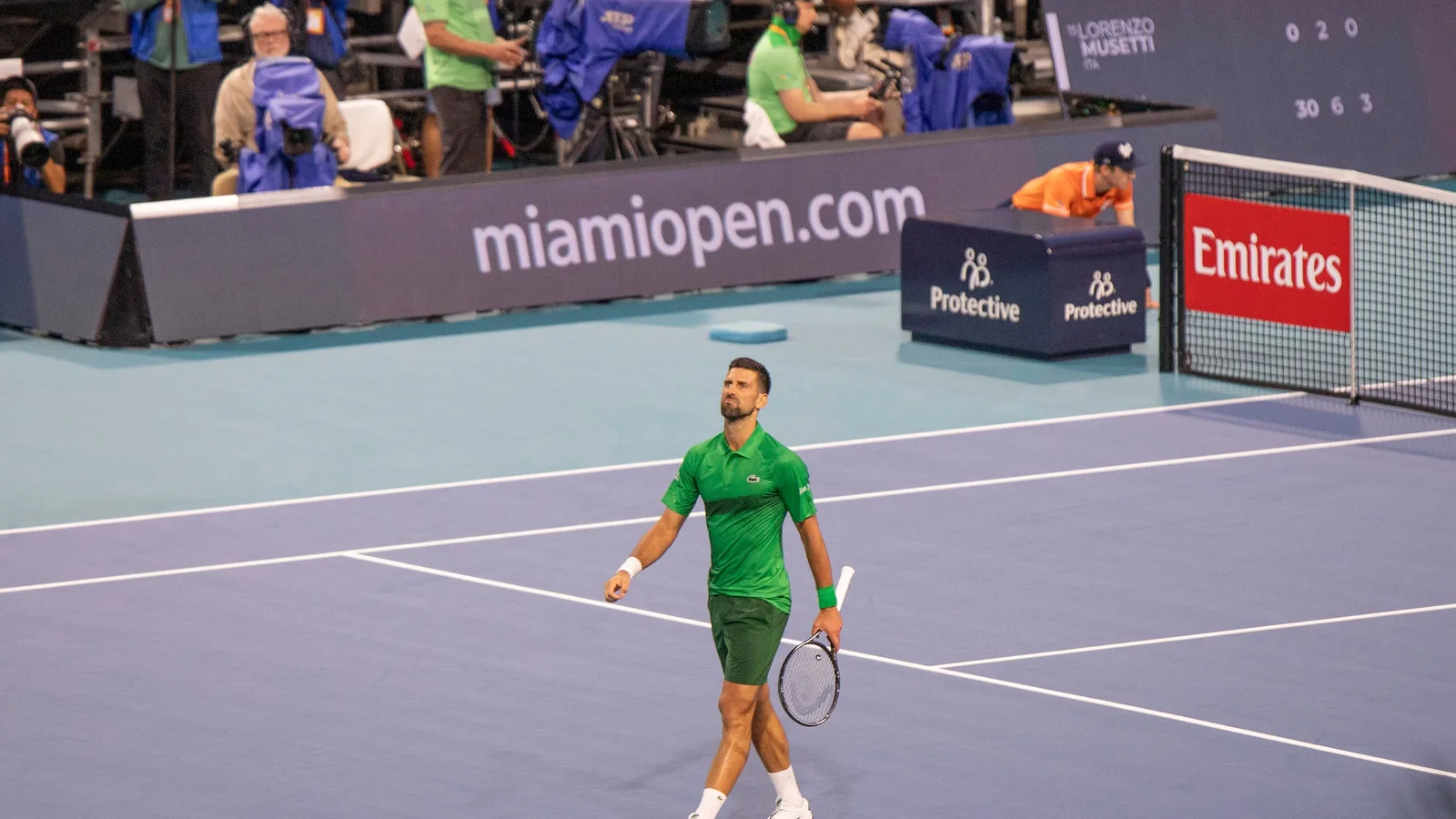 Novak Djokovic walking on a blue hard court at the Miami Open