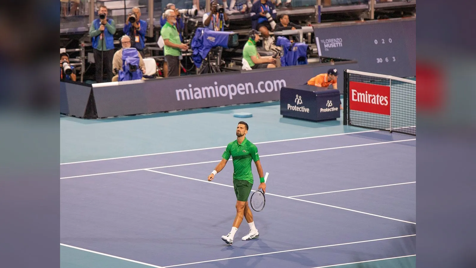 Novak Djokovic walks on court during a match