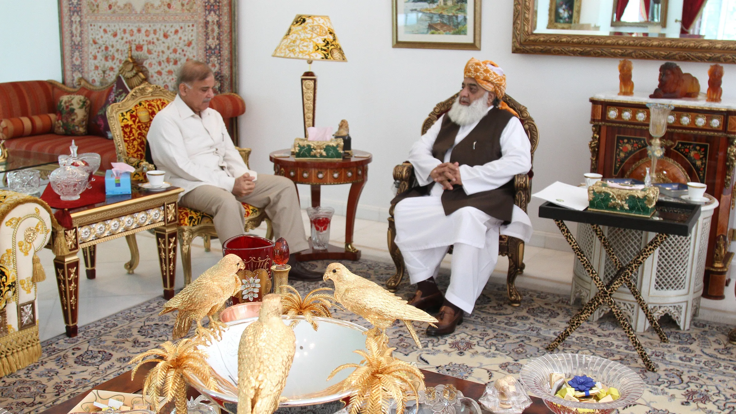 JUI-F chief Maulana Fazlur Rehman seated in a traditional armchair in a drawing room