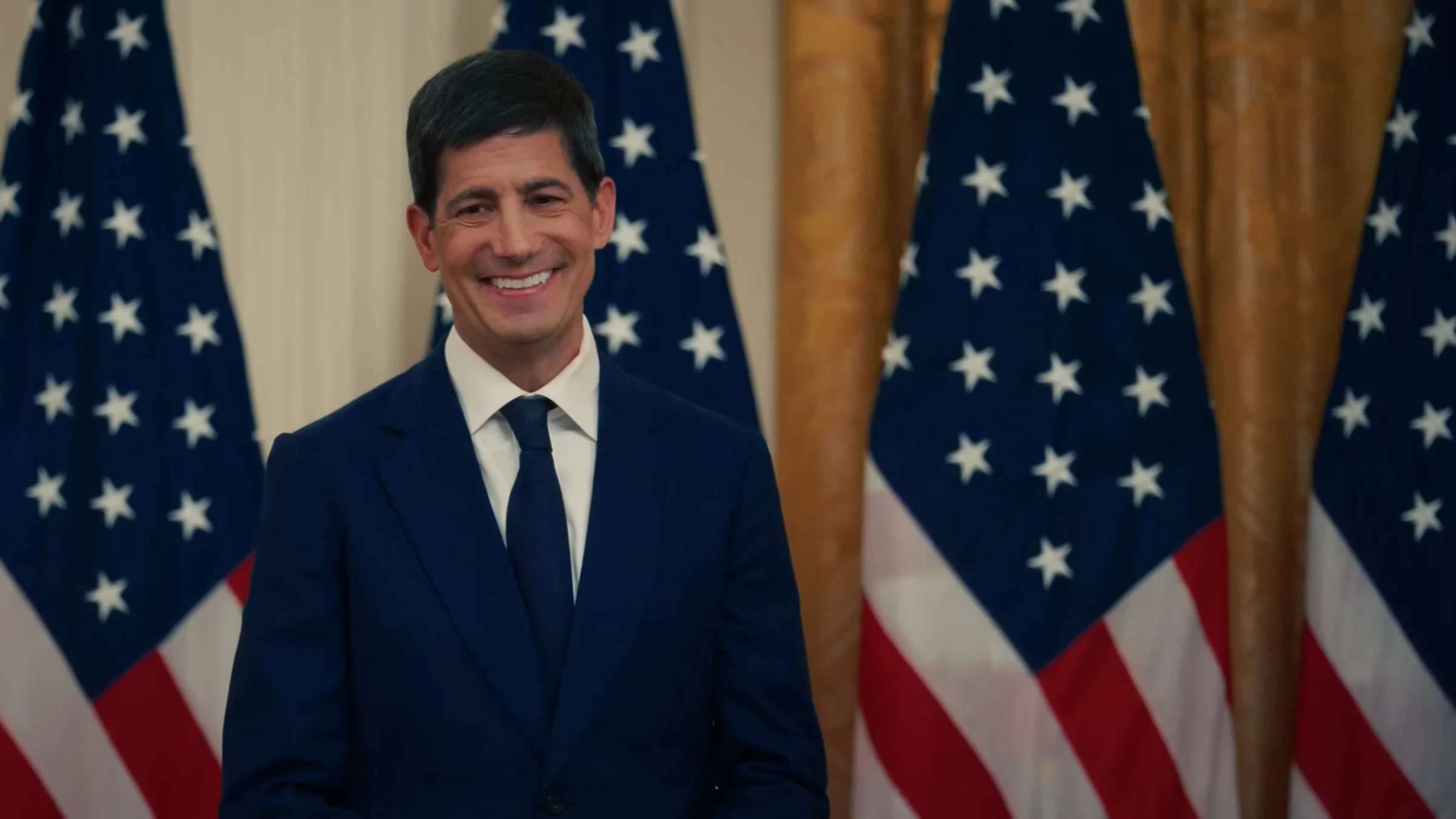 Federal Reserve Chair Kevin Warsh in a dark suit in front of US flags