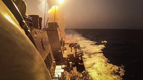 A US warship launches a missile to intercept Houthi missiles at sea