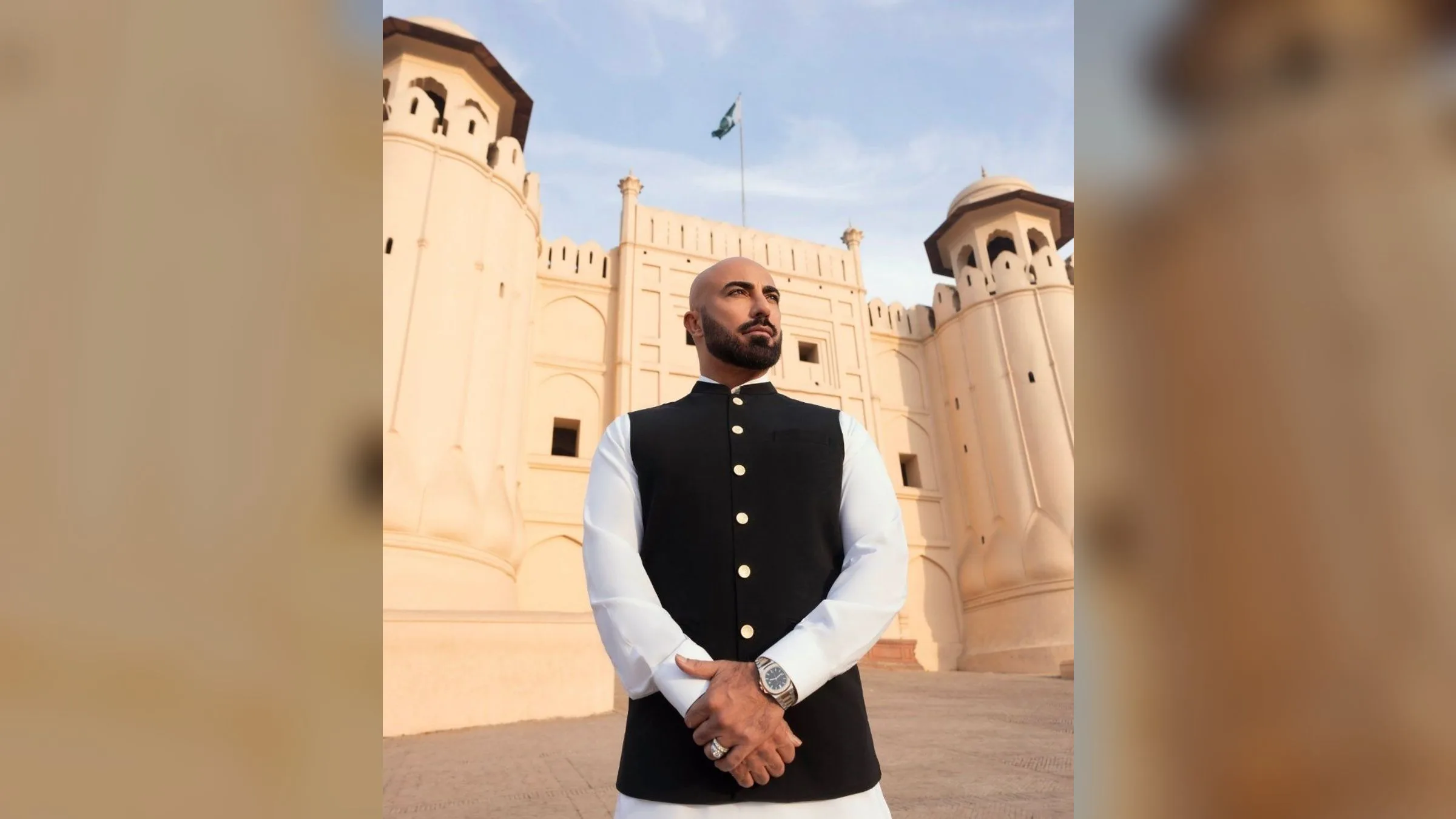 Designer HSY in a black waistcoat and white shalwar kameez at Lahore Fort