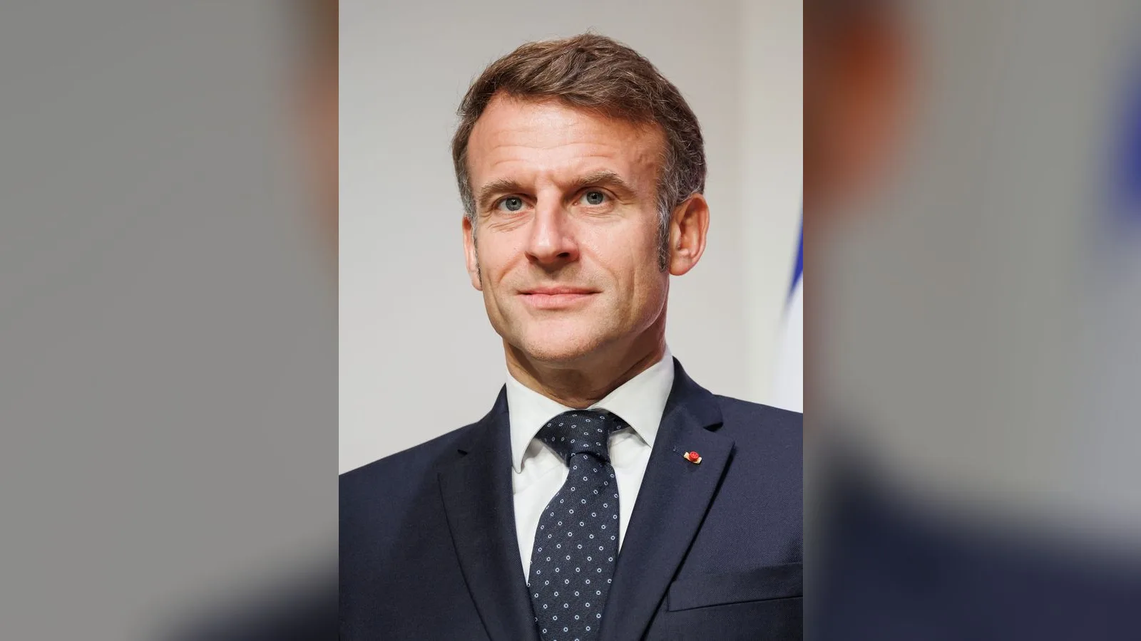 French President Emmanuel Macron in a dark suit and tie