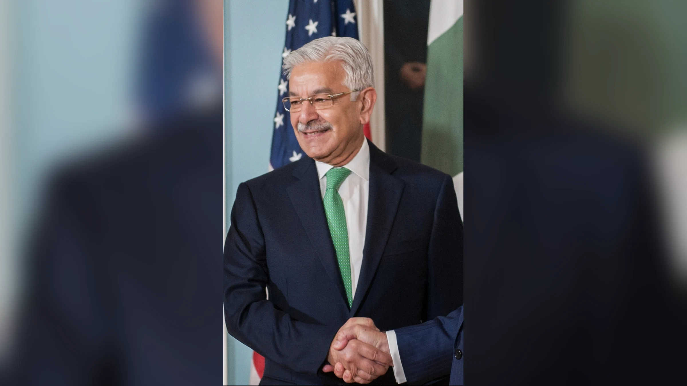 Pakistan's Defence Minister Khawaja Asif in a dark suit and green tie