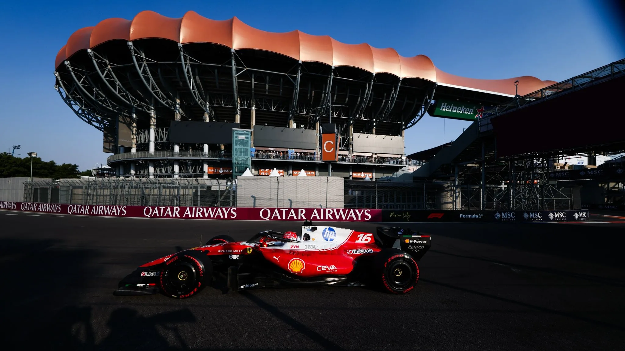 Charles Leclerc's red Ferrari with the Foro Sol grandstand behind it