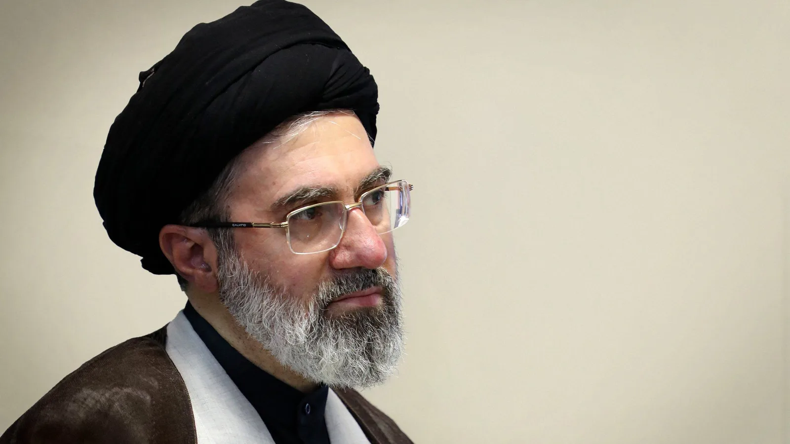 Portrait of Iran's Supreme Leader Mojtaba Khamenei wearing a black turban and glasses