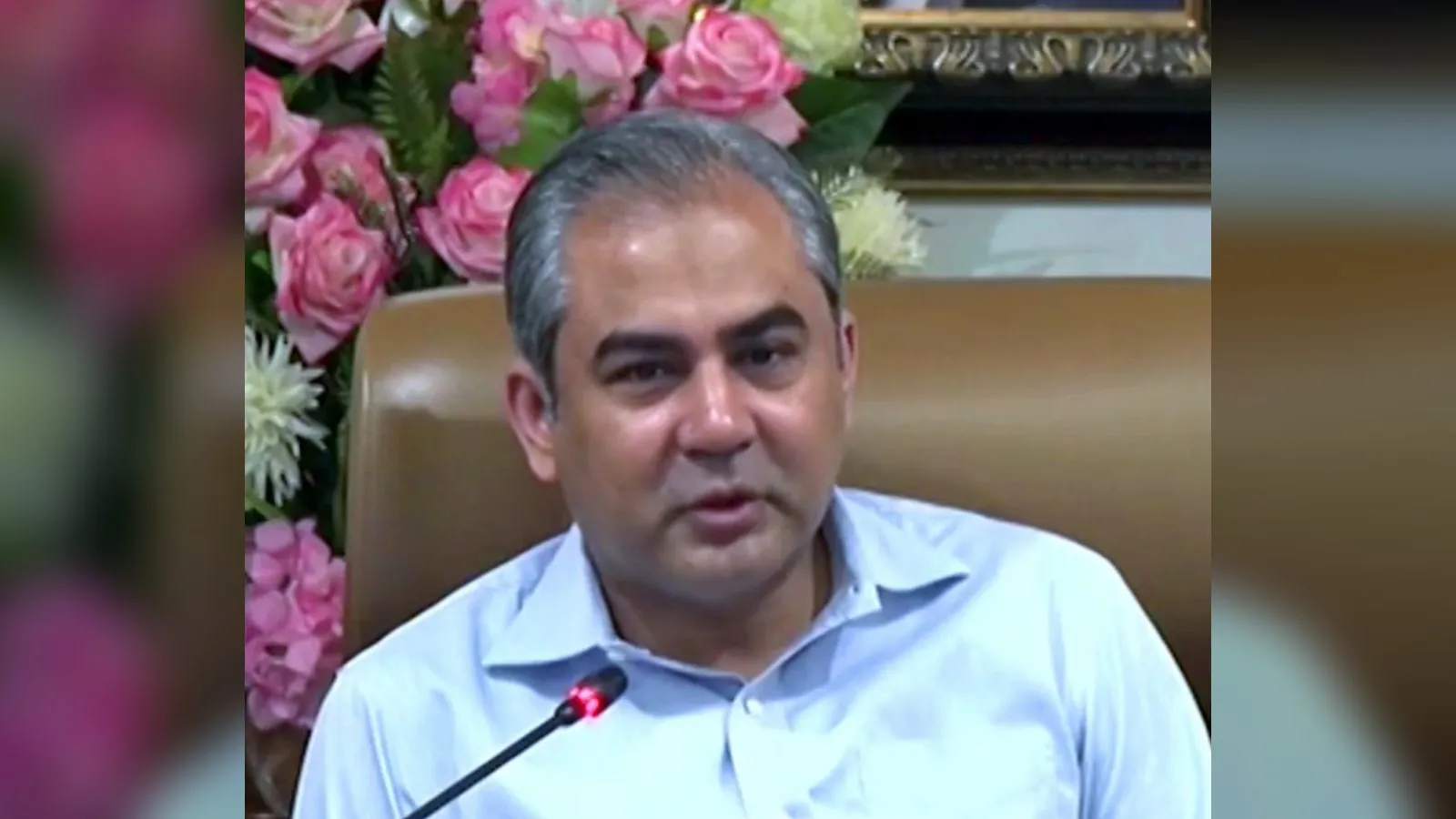 Interior Minister Mohsin Naqvi speaking at a microphone