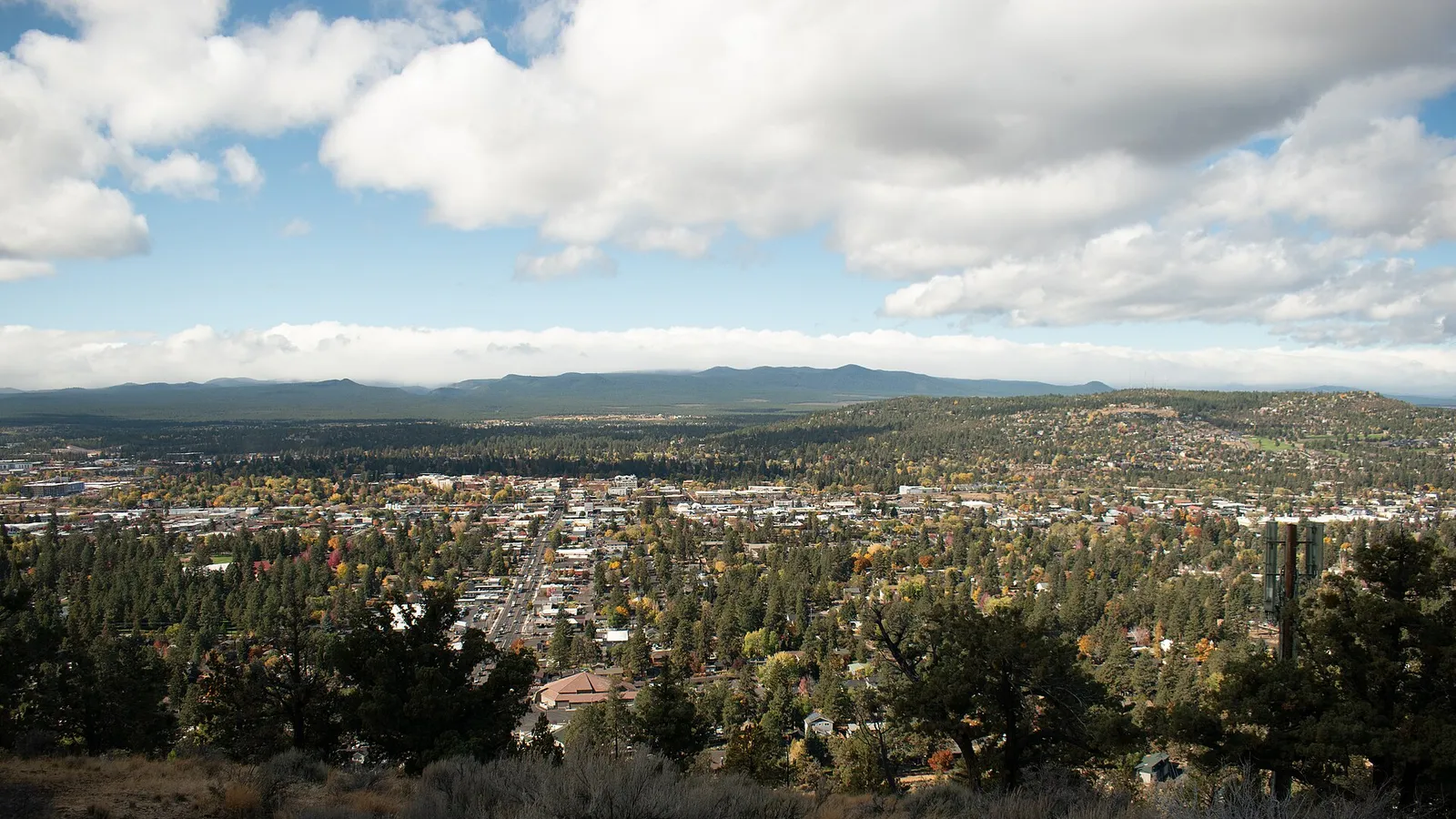 A view over the city of Bend, Oregon, with hills and forest in the distance