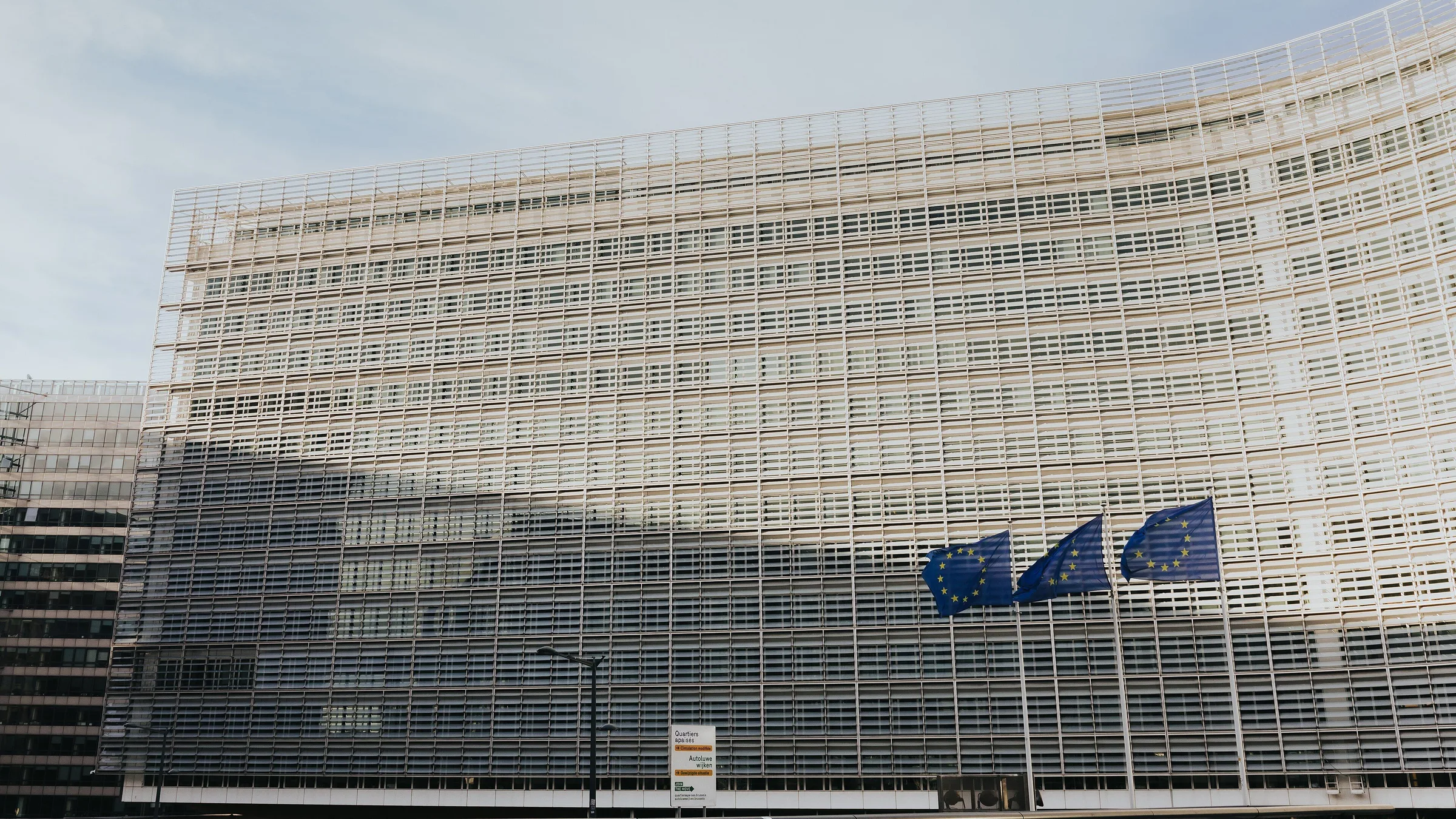 The Berlaymont building in Brussels, headquarters of the European Commission, with EU flags outside