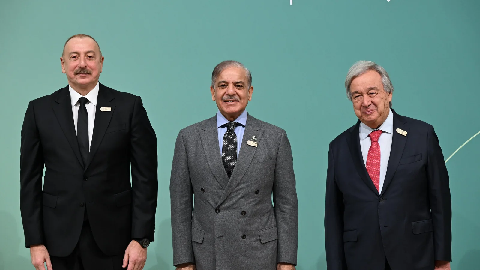 Prime Minister Shehbaz Sharif standing between Azerbaijan's President Ilham Aliyev and UN Secretary-General Antonio Guterres