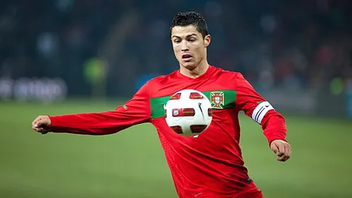 Cristiano Ronaldo strikes the ball in Portugal's red shirt and captain's armband