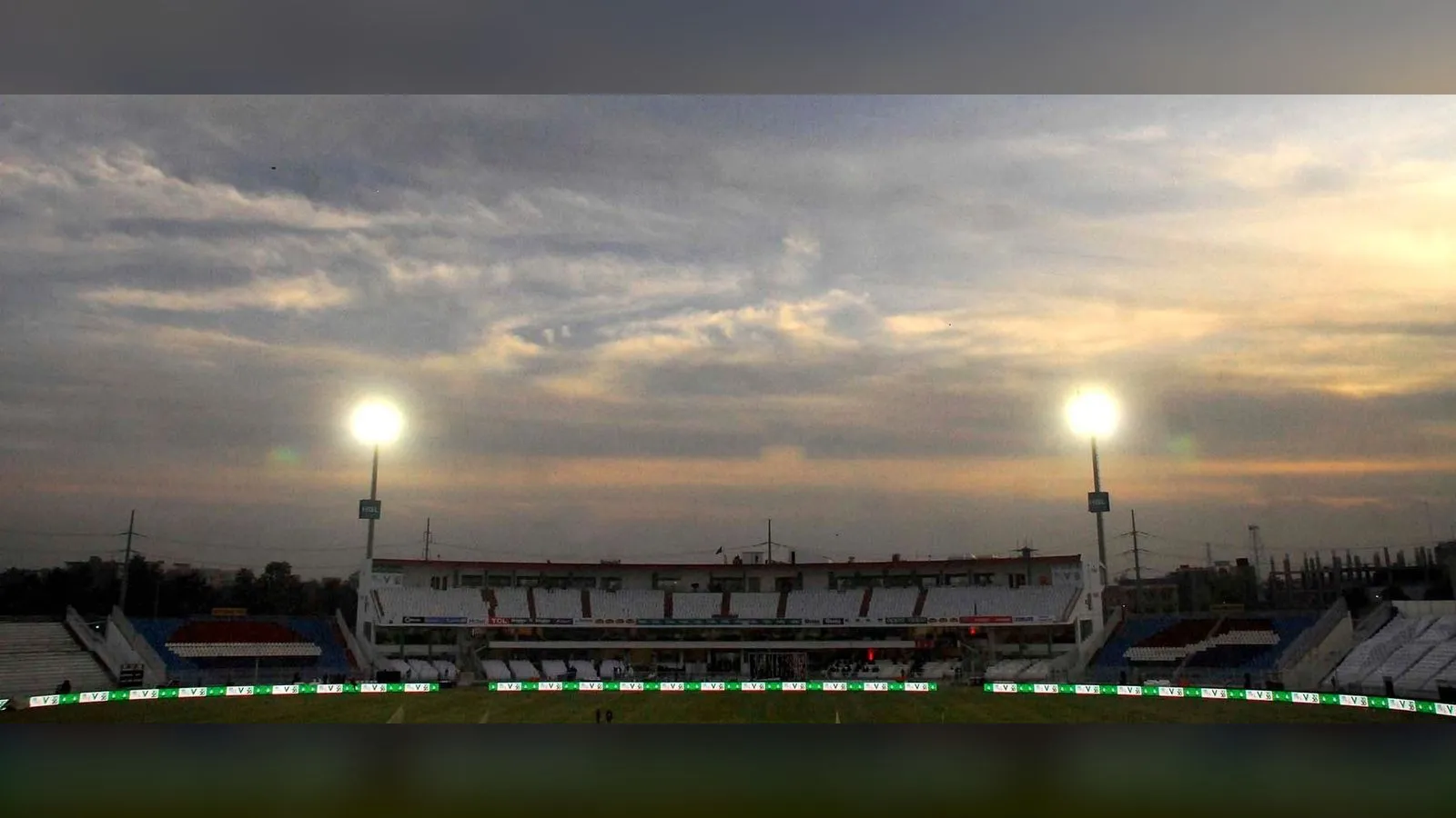 Floodlights shine over the Rawalpindi Cricket Stadium at dusk