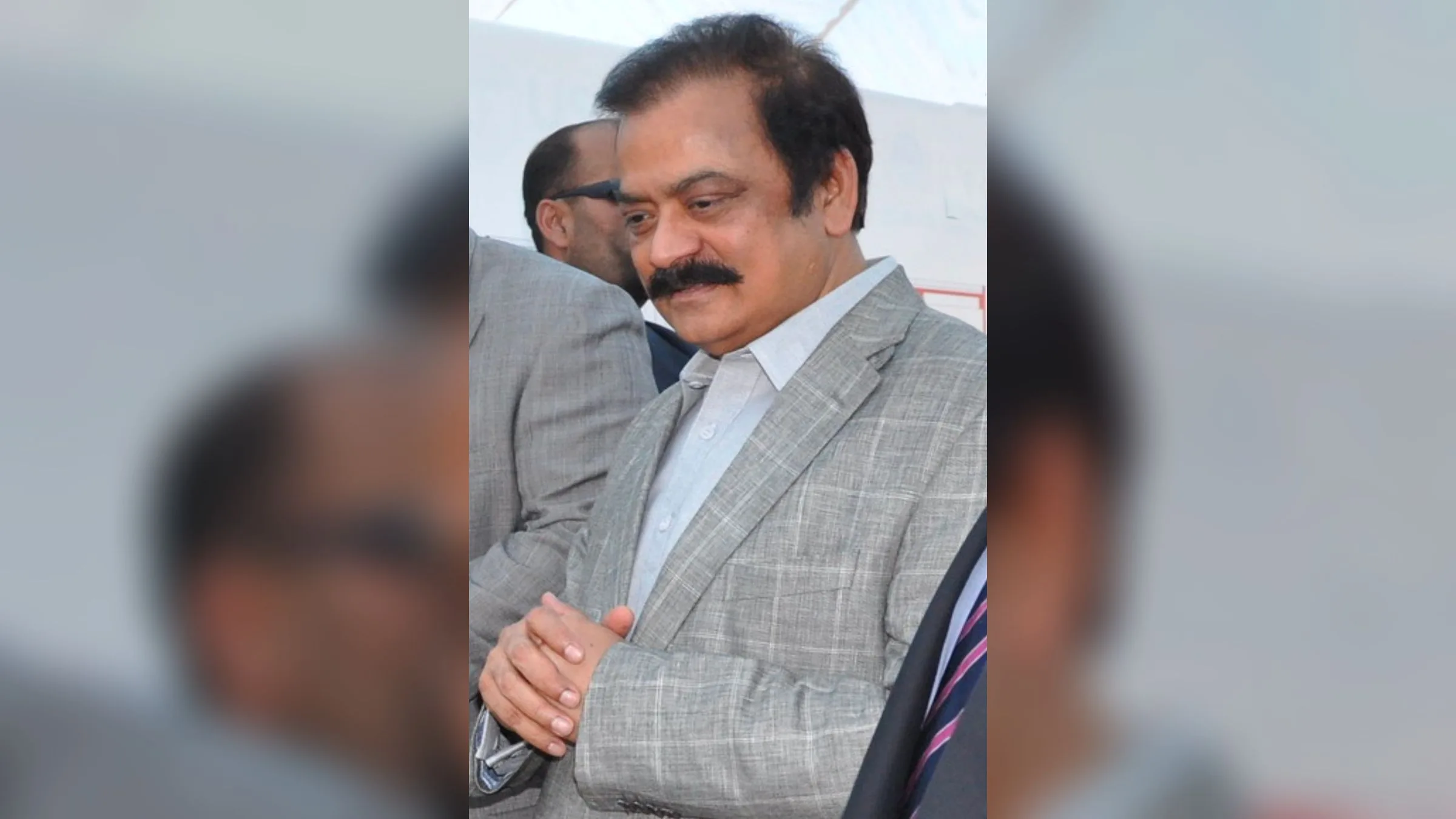 Rana Sanaullah wearing a grey jacket, looking down