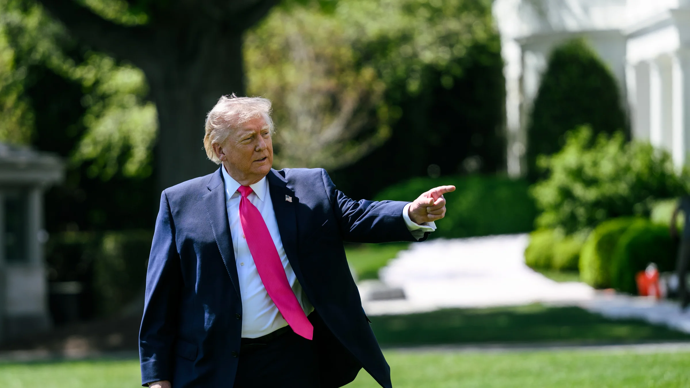 US President Donald Trump gestures as he speaks to reporters on the South Lawn of the White House