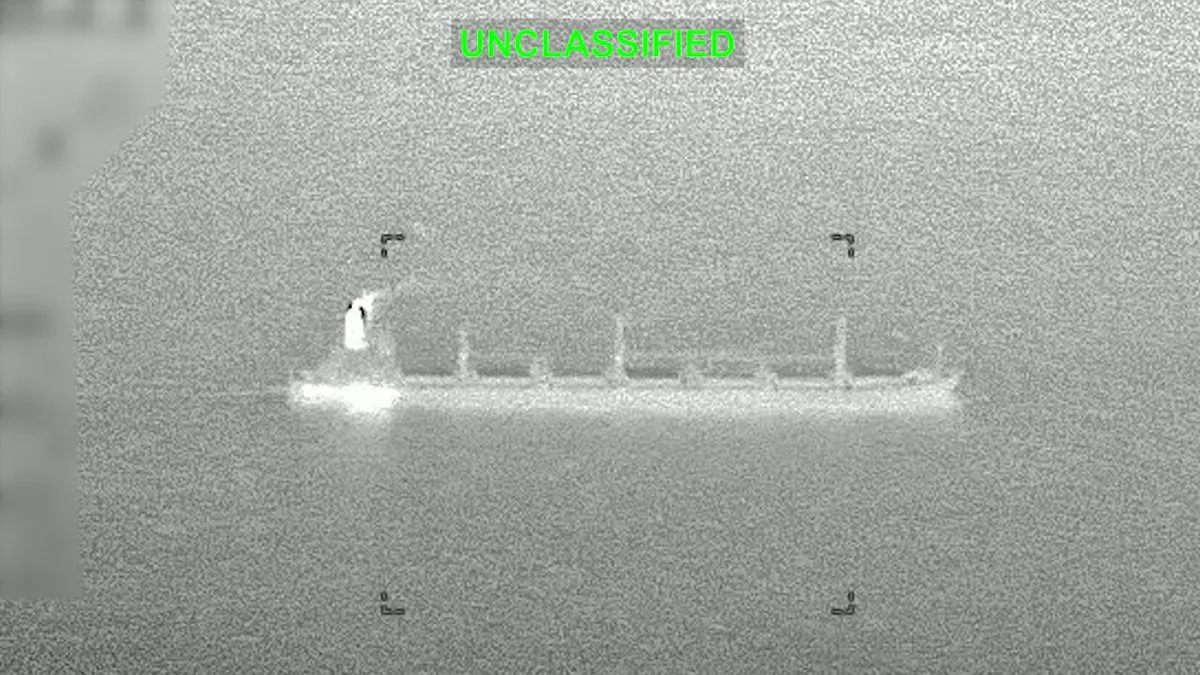 Thermal image of a cargo ship at sea seen through a targeting display