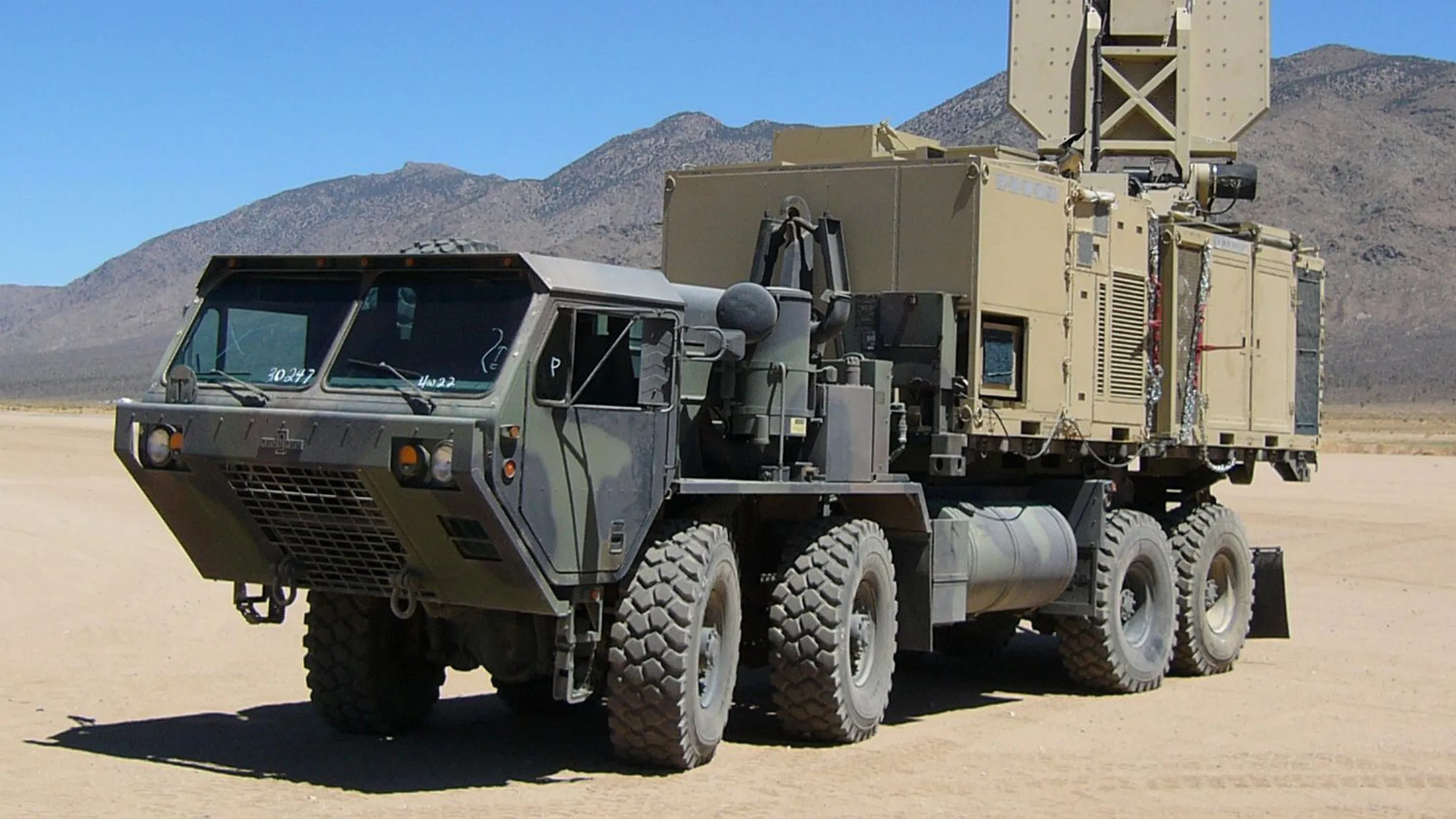 A US military Active Denial System mounted on a large military truck in the desert